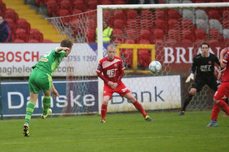 Cliftonville's Stephen Garrett unleashing an unstoppable strike to put Cliftonville 3-0 up. Photo: Pacemaker