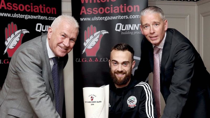 S&eacute;amus McMahon of Quinn Building Products and John Martin, chairman of the Ulster GAA Writers' Association, make the presentation to the September UGAAWA merit award winner Conor Laverty of Kilcoo<br />Picture by Peadar McMahon