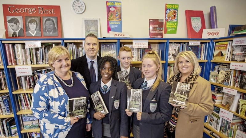 Copies of the late P&aacute;draic Fiacc&#39;s `Ruined Pages&#39;, pictured with Year 11 students from Malone Integrated College with Principal Katrina Moore, James Kerr from Verbal Arts and Gilly Campbell from the Arts Council 