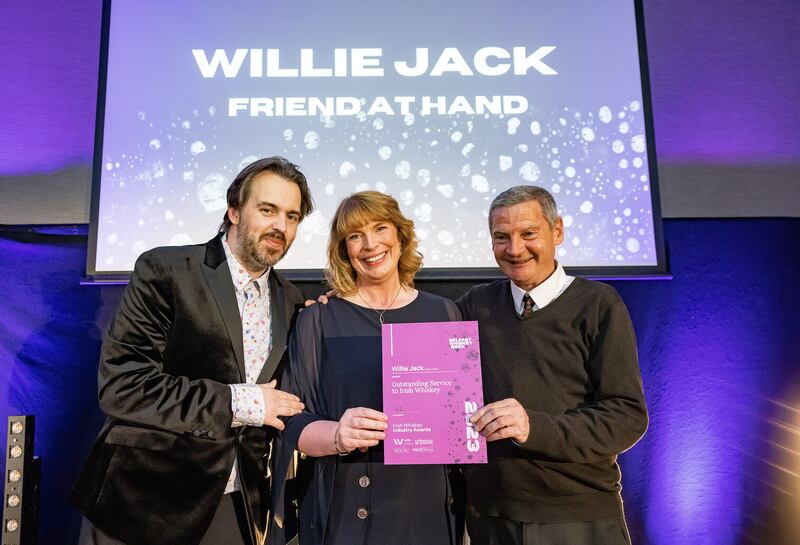 Belfast Whiskey Week Festival founder Paul Kane, Helen Mulholland (Irish Whiskey Master Blender at Athrú Whiskey and new Vice Chairperson for the Irish Whiskey Association), and Ray Gallen from The Friend At Hand, who collected the award on behalf of Willie Jack for Outstanding Service to Irish Whiskey.