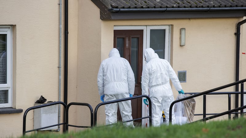 PSNI forensic officers at a property in the Edward Street area of Lurgan, Co Armagh, as two women and a man have been arrested and police have launched a murder investigation (Liam McBurney/PA)