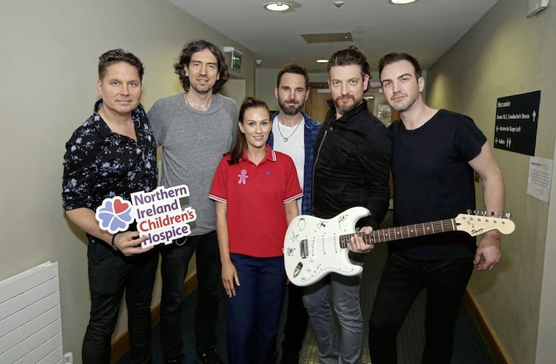 Snow Patrol have donated a signed guitar to Northern Ireland Children&rsquo;s Hospice. The band are pictured with NI Children&rsquo;s Hospice staff nurse Jenny Thompson. Picture by Kelvin Boyes, Press Eye