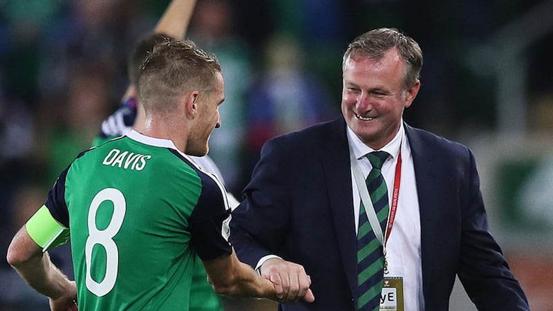 Northern Ireland manager Michael O'Neill celebrates with Steven Davis after the 2018 FIFA World Cup Qualifying, Group C match at Windsor Park, Belfast&nbsp;