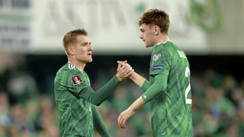 Northern Ireland captain Steven Davis (left) greets Conor Bradley after the teenager's competitive debut against Switzerland earlier this month.