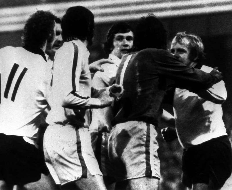 Leeds goalkeeper David Harvey (in the dark shirt) separates team-mate Norman Hunter (centre) and Derby s Francis Lee (right) 