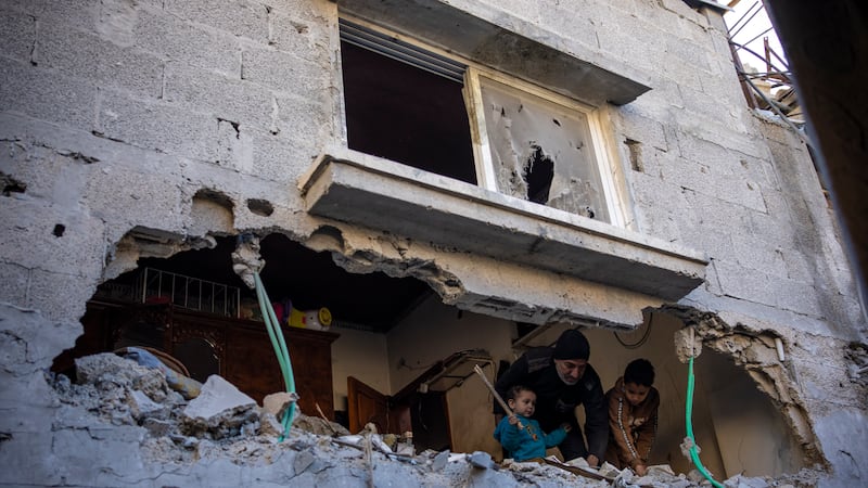 Palestinians check the destruction after an Israeli strike in Rafah, southern Gaza Strip, on Thursday (Fatima Shbair/AP)