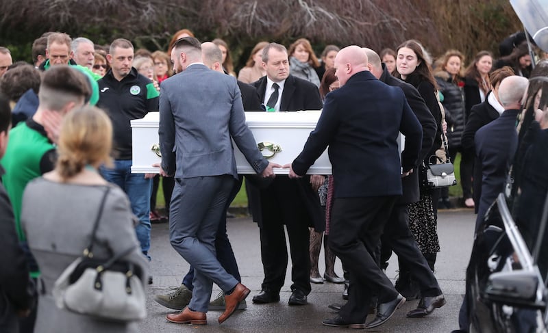 Andrew McGinley (centre) watches as a coffin of one of his three children is carried into the Church of the Holy Family in Rathcoole, Dublin during the funeral of siblings Conor, Darragh and Carla McGinley at the Church of the Holy Family in Rathcoole, Dublin. Picture by Niall Carson/PA Wire&nbsp;