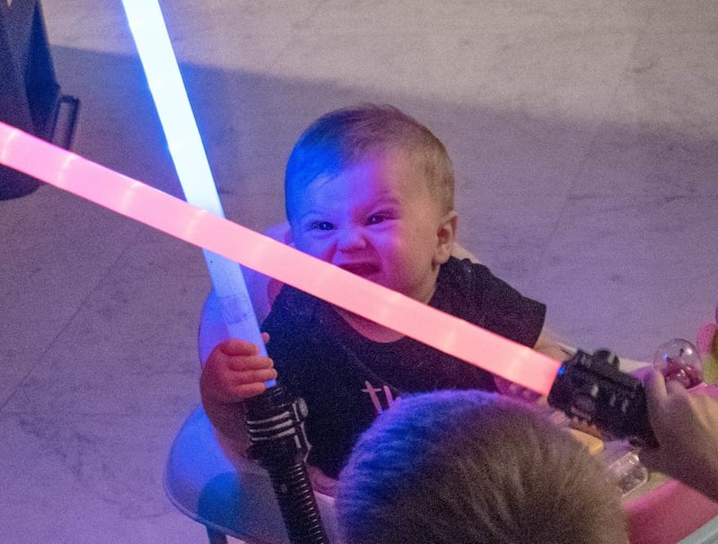 A baby with a lightsaber