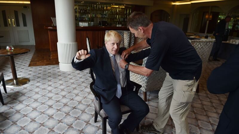 Boris Johnson has a microphone attached to his jacket as he gives a television interview before a Hustings event at the Culloden House Hotel in Belfast&nbsp;