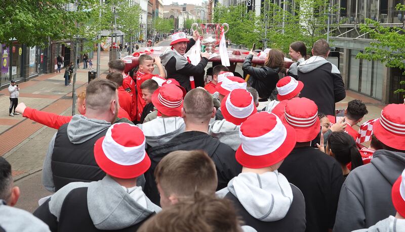 Cliftonville celebrate with the fans during an open top bus tour across Belfast after winning the Irish Cup oat Windsor on Saturday.
PIC COLM LENAGHAN