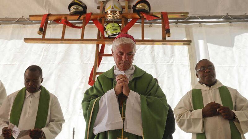 A cross made with ladders and firefighter helmets is placed inside a tent during a Mass celebrated by Bishop Giovanni D&#39;Ercole. Picture by AP 