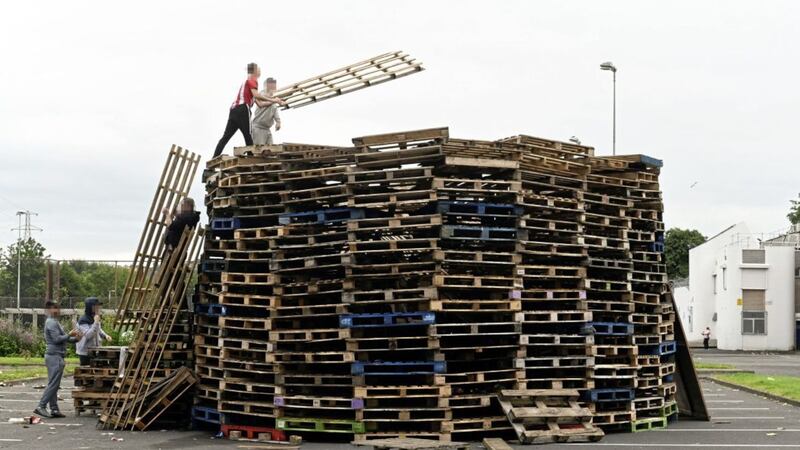 &nbsp;Bonfire builders this afternoon adding to the pyre built in a car park at Avoniel Leisure Centre in east Belfast. Picture by Justin Kernoghan
