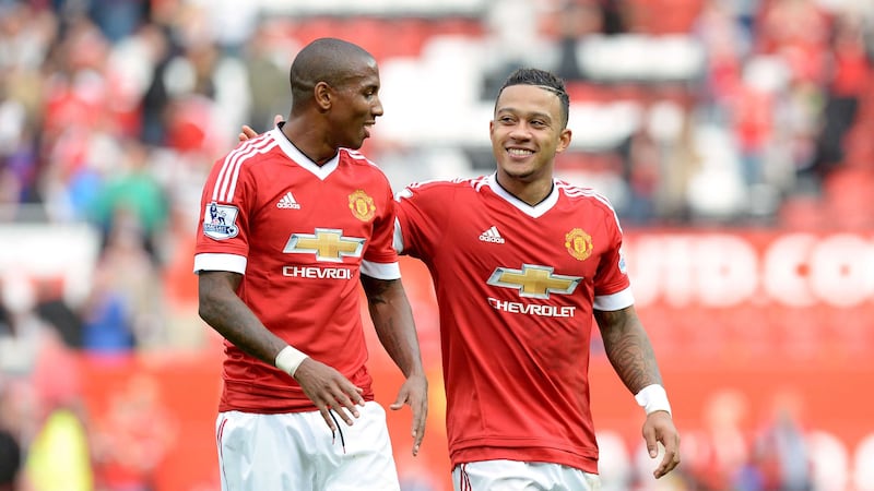 Manchester United's Memphis Depay and Ashley Young (left) are all smiles as they celebrate victory against Sunderland