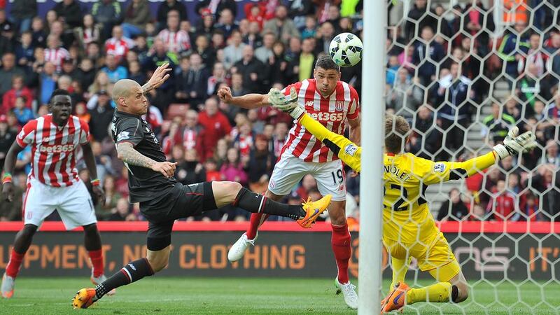Ireland striker Jonathan Walters scores the third of the six goals Stoke put past Liverpool at the Britannia Stadium on Sunday Picture: PA 
