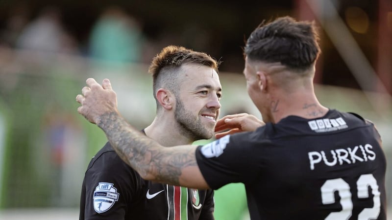 Glentoran&#39;s Conor McMenamin is congratulated by team-mate Daniel Purkis after scoring against Dungannon Swifts at the Oval on Saturday Picture by Desmond Loughery/Pacemaker 