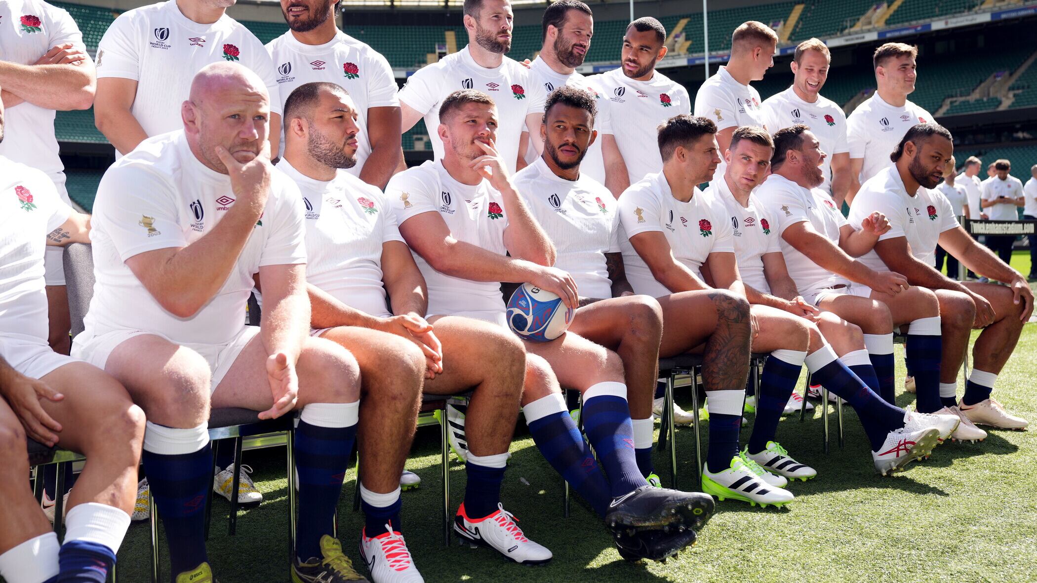 England captain Owen Farrell (holding rugby ball) with World Cup squad yesterday at Twickenham