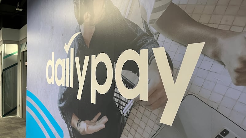 Interior office signage of the DailyPay brand.