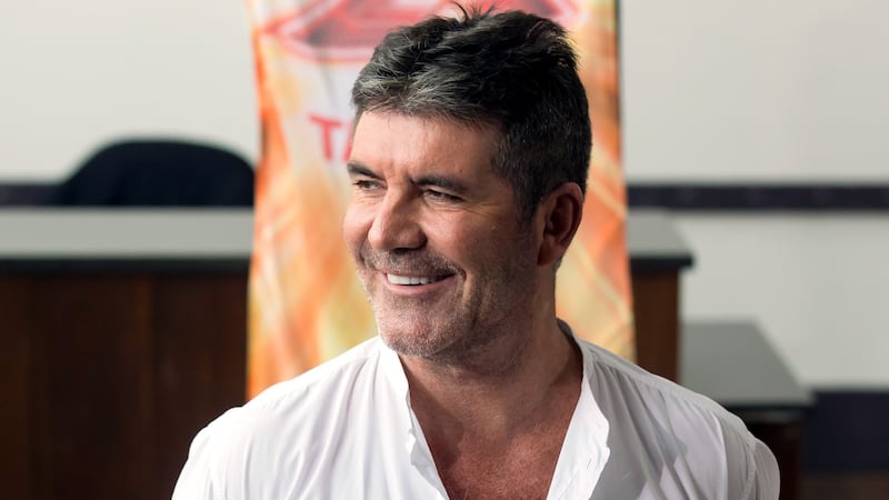 Simon Cowell and Cheryl play a game of Stick On Your Head on X Factor.
