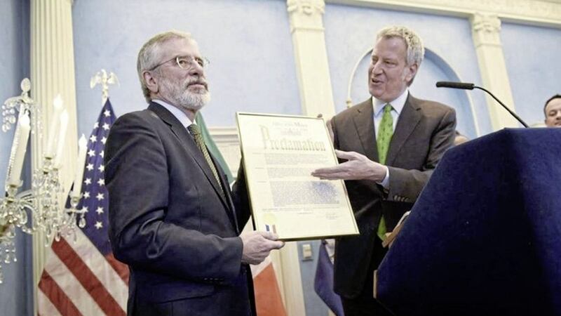 Gerry Adams is presented with a certificate by New York mayor Bill de Blasio 