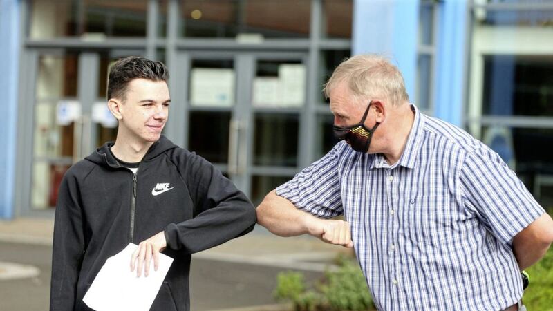La Salle teacher Paul Buchanan congratulates a pupil as he receives his GCSE results last week. Picture by Mal McCann 