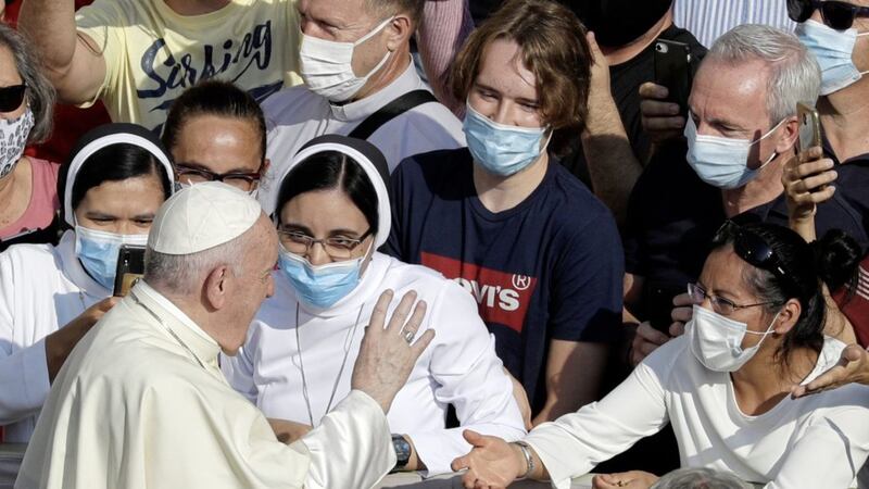 Pope Francis, pictured greeting the faithful wearing face masks at the Vatican last week, will publish his &#39;pandemic encyclical&#39; next month. Picture by AP Photo/Gregorio Borgia 