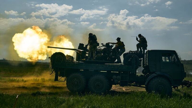 Ukrainian soldiers fire a cannon near Bakhmut (AP)