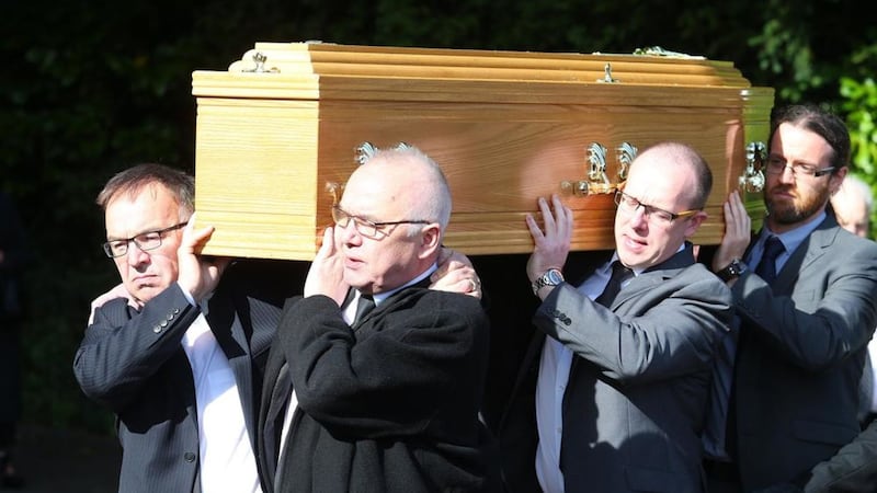 The coffin of Paddy O'Flaherty is carried from St Gerard's Church. Hundreds of mourners gathered on Friday to say their final farewells to the veteran BBC journalist.