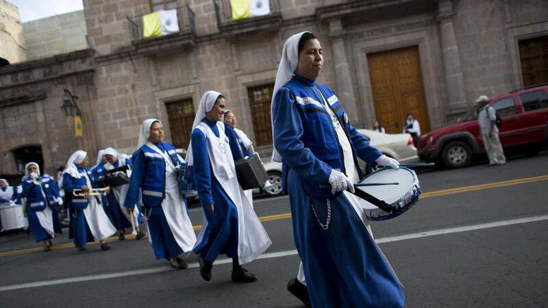 A marching band of nuns, from Monterrey, play their instruments as they spontaneously parade ahead of Pope Francis&#39;s arrival, in Morelia, in the Mexican state of Michoacan 