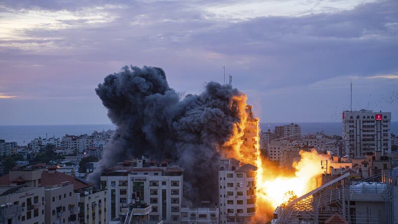 Fire and smoke rise following an Israeli air strike in Gaza City (Fatima Shbair/AP)
