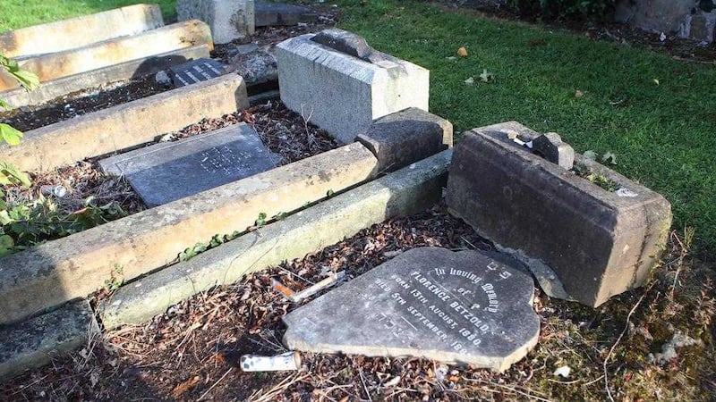 Some of the damaged headstones in the Jewish plot in Belfast Cemetery. Picture by Matt Bohill