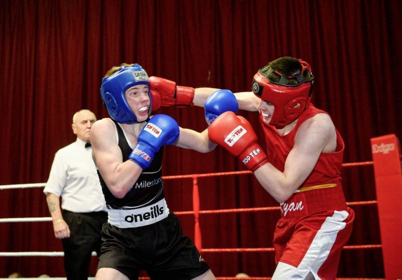 Clonard&#39;s Ryan Johnston lands a looping right hook on his way to defeating Rathfriland&#39;s Daniel Waugh in their boy 5 54kg Antrim final at Corpus Christi last week. Picture by Mark Marlow 