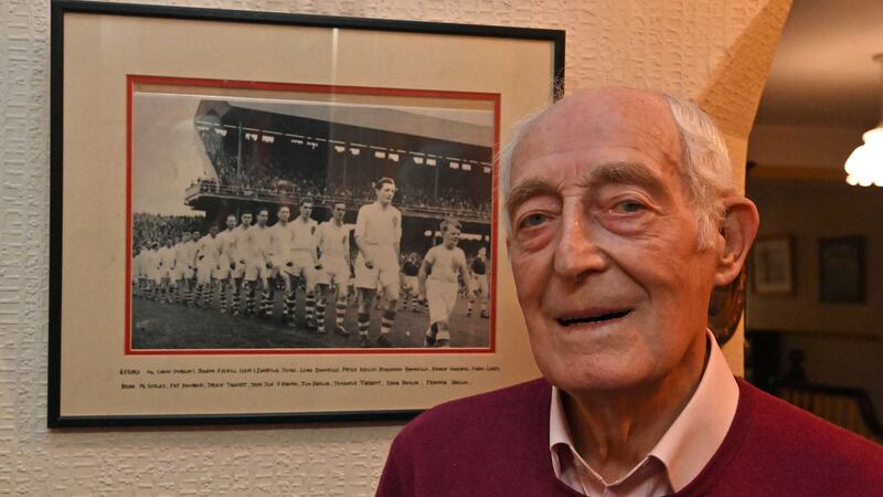 Tyrone legend Jody O'Neill, next to a framed photograph of him leading the Red Hands out at Croke Park in 1956. Pic: Oliver McVeigh