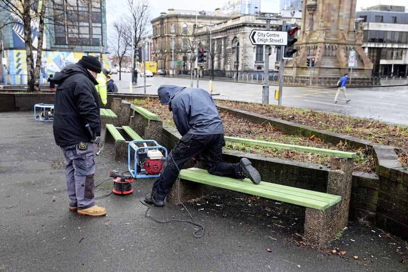 Teams from Belfast City Council get to work replacing the benches. Picture by Mal McCann 