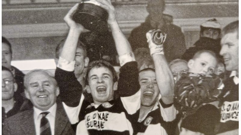 Emmett McKeever lifts the Seamus McFerran Cup after Dungiven&rsquo;s Ulster Club SFC win in 1997, seven years after being part of the club&rsquo;s win in the Ulster Club Minor Football Tournament at St Paul&rsquo;s. McKeever is now joint-manager of the Dungiven team facing Four Masters in Sunday&#39;s final. Picture: History of St Canice&#39;s GAC book 