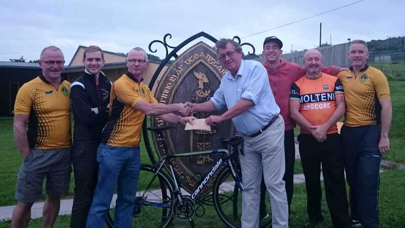 Members of St Enda's Glengormley took part in a cycle to Carrick-On-Shannon to raise funds for motor neurone disease (MND). Mickey Devlin, chairman of the club's cycling group, left, presents Stephen Thompson, chairman of the Northern Ireland branch of the Motor Neurone Disease Association, with a cheque worth &pound;1,100