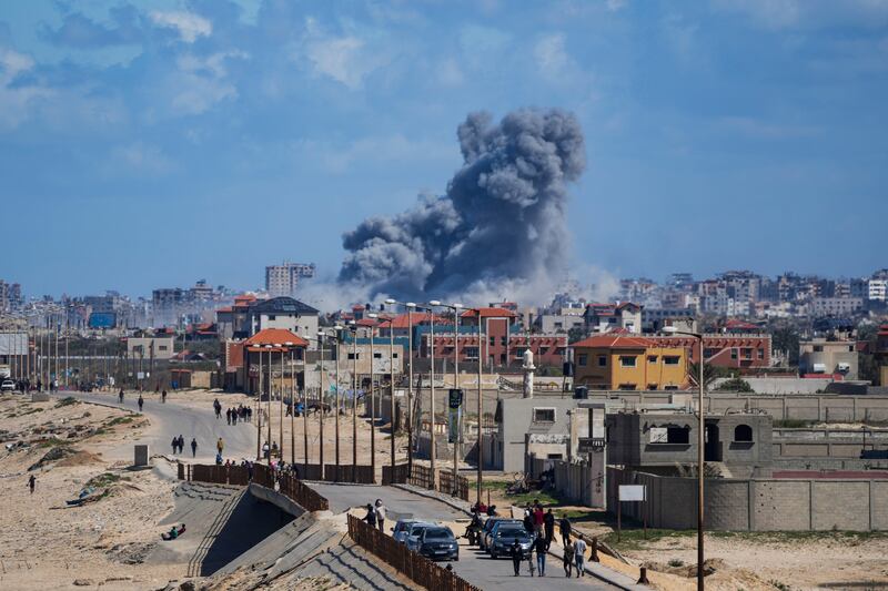 Smoke rises following an Israeli air strike in the central Gaza Strip (Abdel Kareem Hana/AP)