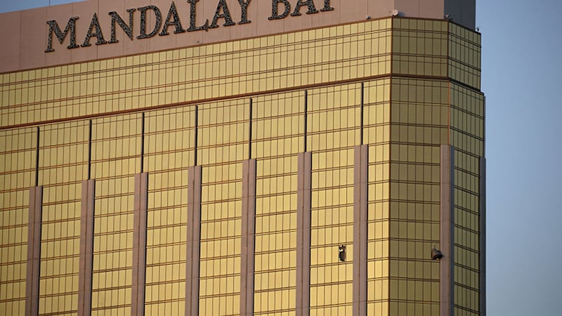 Curtains billow out of broken windows at the Mandalay Bay resort and casino Monday, October 2, 2017, on the Las Vegas Strip following a deadly shooting at a music festival&nbsp;