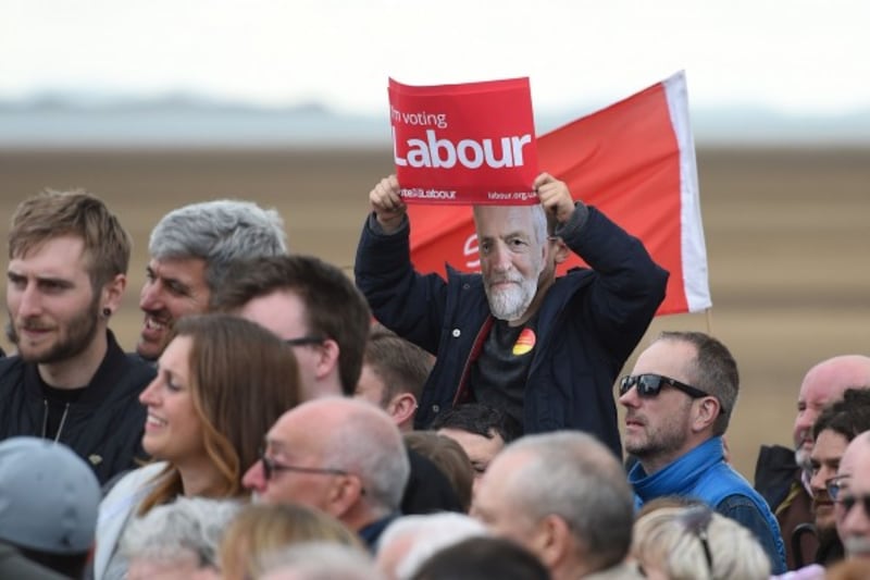 A supporter wears a Jeremy Corbyn mask