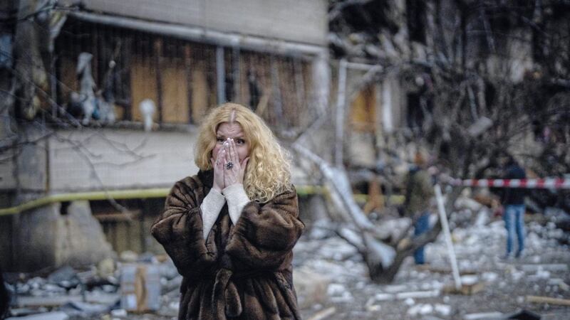 Natali Sevriukova reacts as she stands next to her house following a rocket attack in the city of Kyiv, Ukraine last Friday 