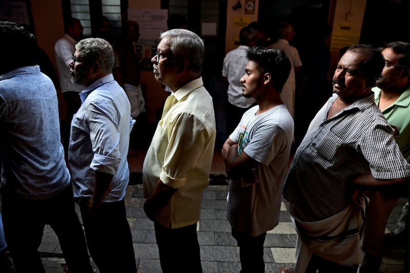 People queue up to vote during the second round of voting in the six-week long national election outside a polling booth in Kochi (R S Iyer/AP)