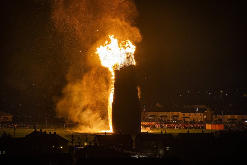 People watch the burning of the Craigyhill loyalist bonfire in Larne, Co Antrim,. Picture date: Wednesday July 12, 2023.