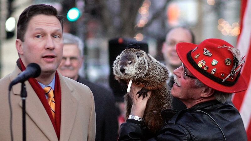 Sun Prairie Mayor John Murray, left, predicts spring after communicating with Jimmy, Wisconsin’s answer to Punxsutawney Phil, held by caretaker Jerry Hahn, in Sun Praire, Wisconsin (Craig Schreiner/Wisconsin State Journal/AP)