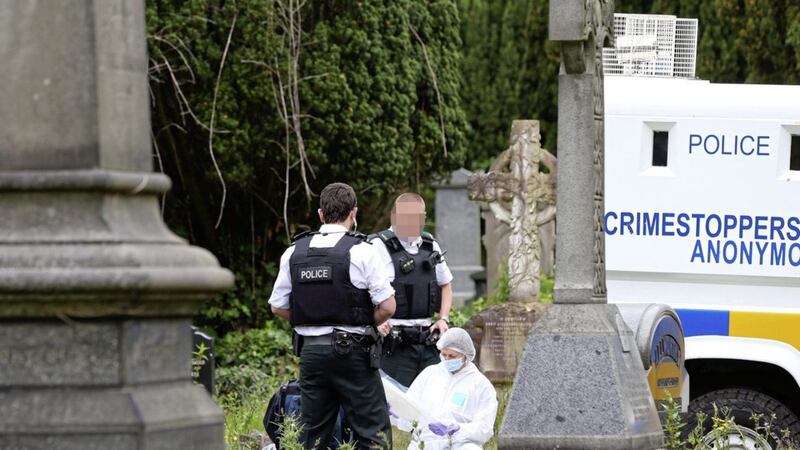 Police and forensic officers examine a suspect device in the City Cemetery in west Belfast. Picture by Mal McCann 
