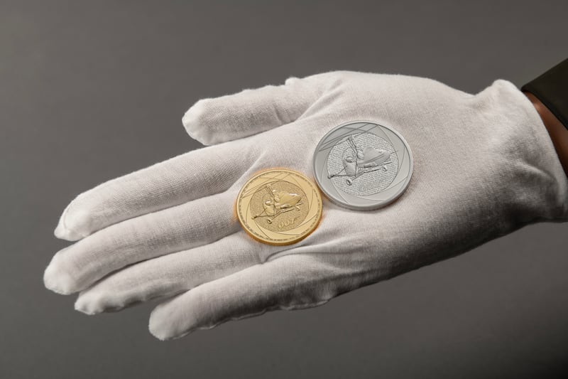 Two Bond coins in a hand