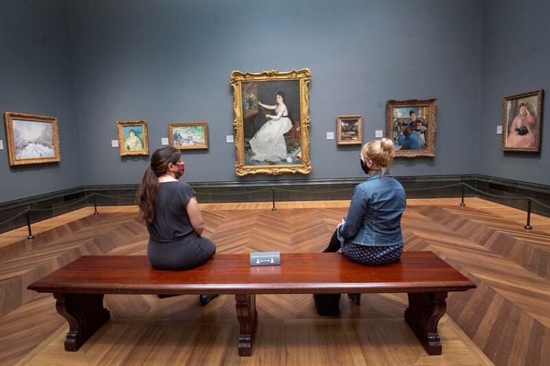 Visitors wearing PPE sit apart at the National Gallery