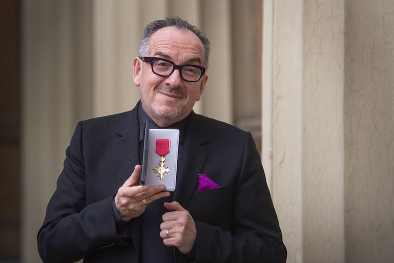 Elvis Costello, real name Declan McManus, with his OBE for services to music following an investiture ceremony at Buckingham Palace, London. Picture by Victoria Jones/PA Wire&nbsp;