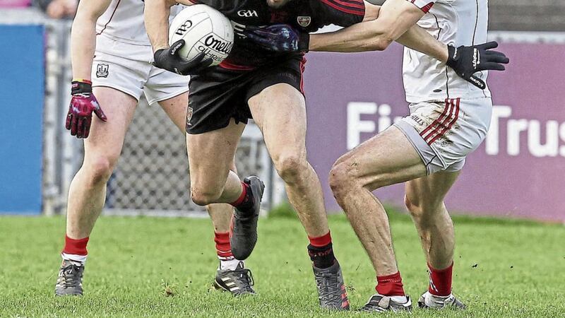 Connaire Harrison (centre) was part of a two-man Down inside forward line against Cork at Pairc Esler. His fellow attacker Donal O&rsquo;Hare barely touched the ball in the first half Picture: Philip Walsh 