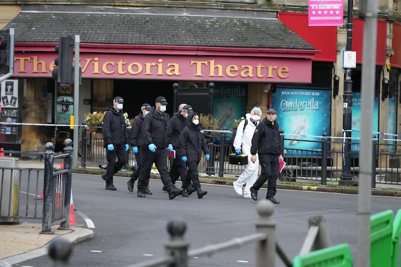 Police and forensic officers outside The Victoria Theatre near the scene of a triple stabbing in Commercial Street in Halifax