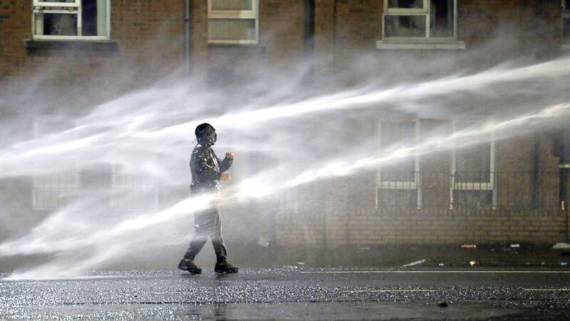 &nbsp;A nationalist rioter is hit by jet from the PSNI water cannon on the Springfield Road on April 8 2021. Picture by Stephen Davison, PA