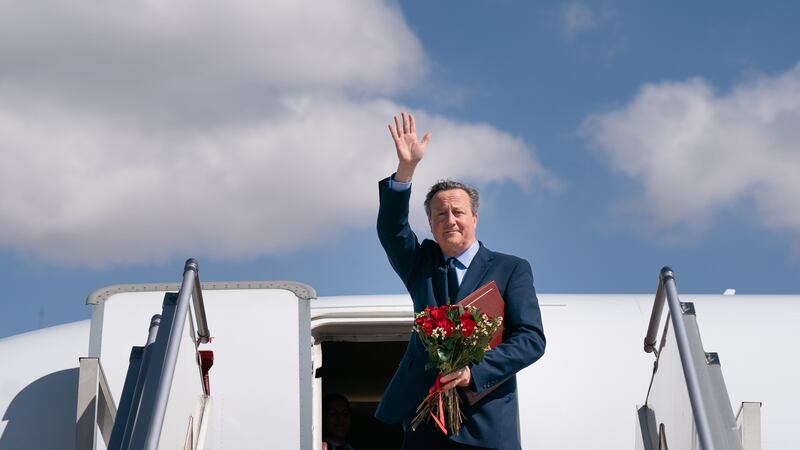 Foreign Secretary Lord David Cameron waves as he boards his plane in Ulaanbaatar, Mongolia, on the last day of his five day tour of the Central Asia region